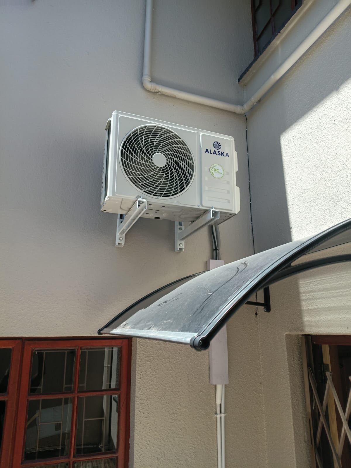 Alaska outdoor condenser mounted on wall brackets in Gauteng
