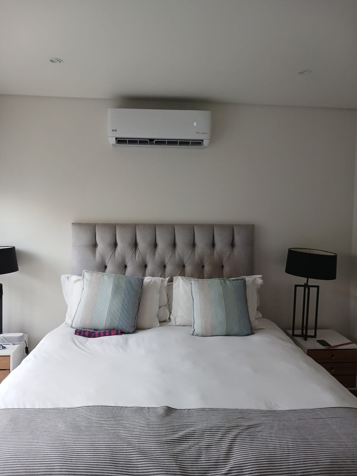 Air conditioner installed above a bedroom headboard in Gauteng