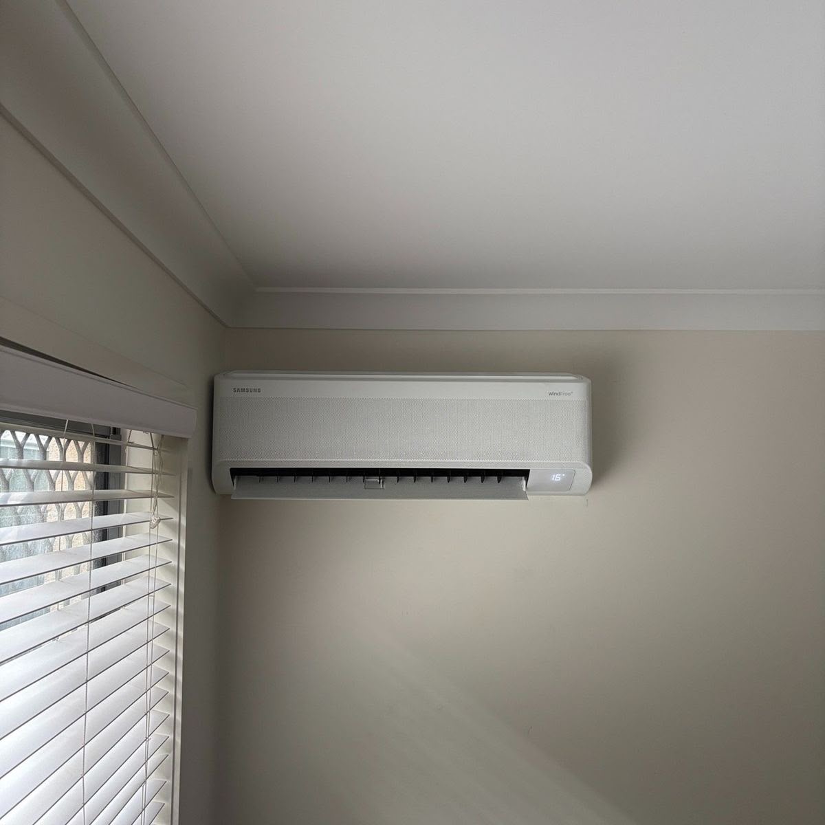Indoor air conditioner installed beside window blinds in Gauteng