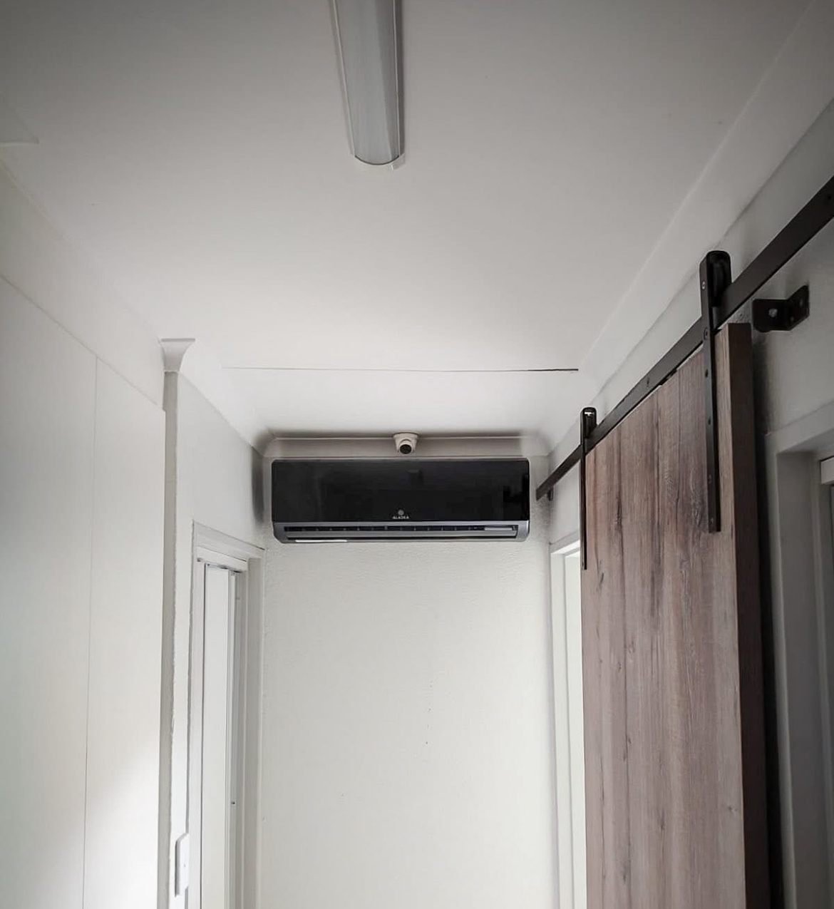 Black Alaska Air Conditioner installed in a hallway