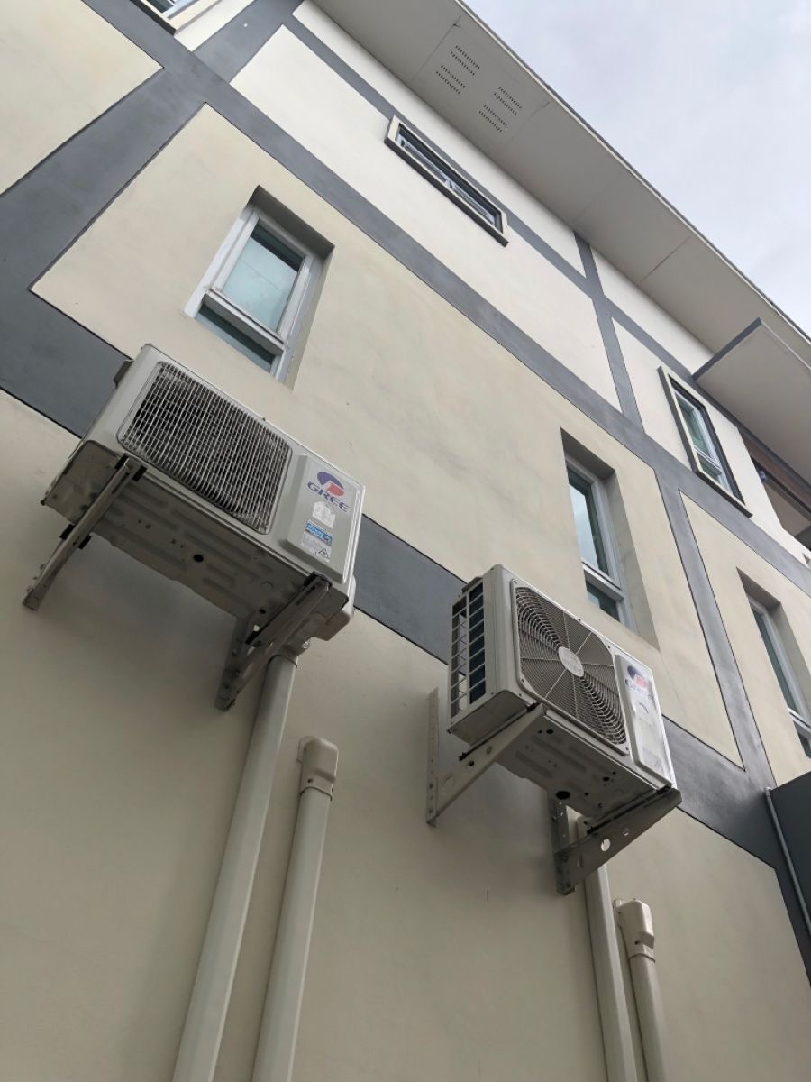 Outdoor compressor units installed neatly on a complex