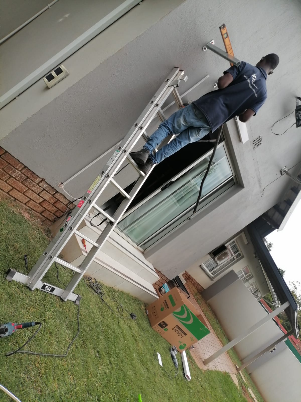 Blue Line technician installing an aircon bracket