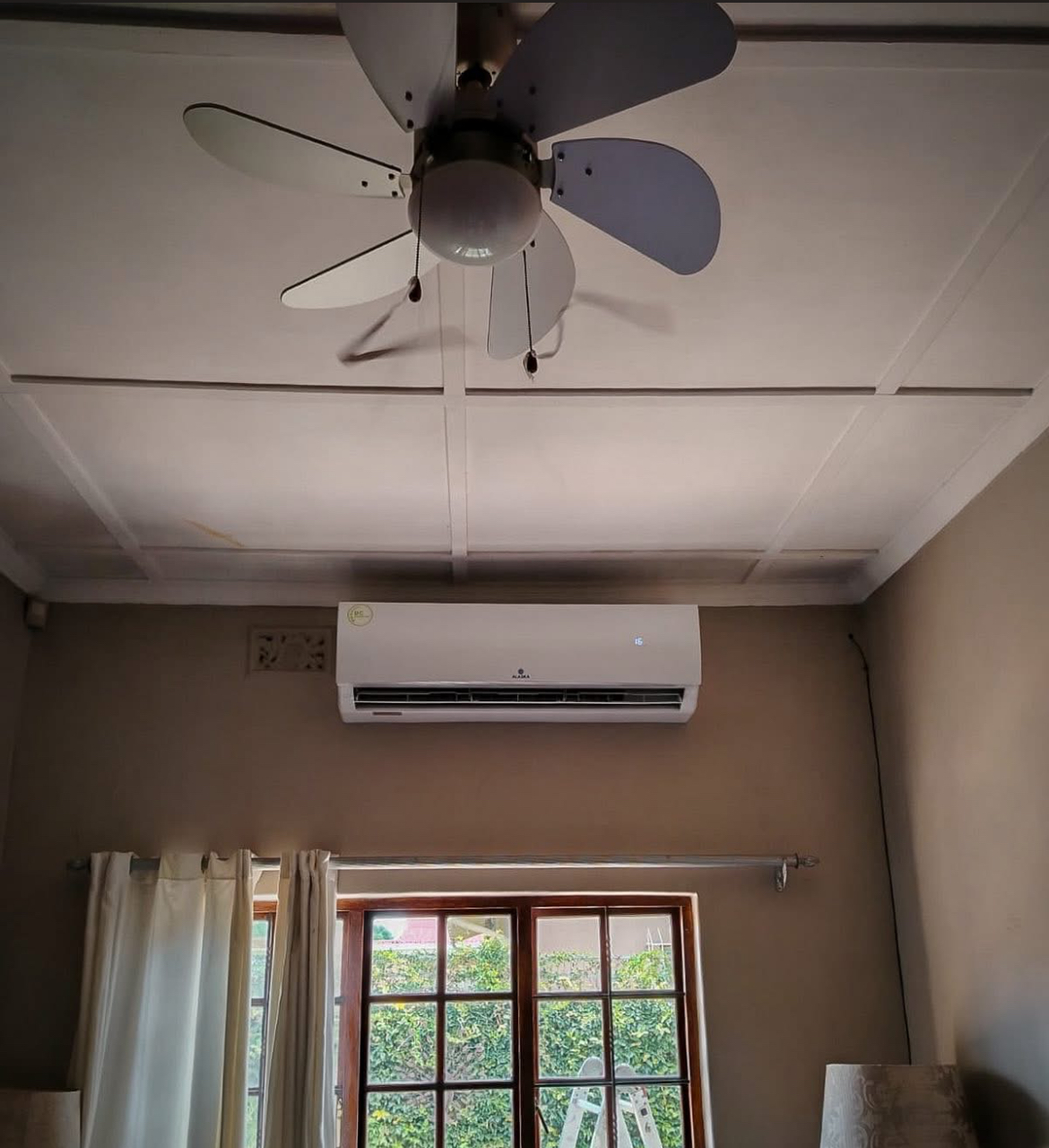 Alaska Air Conditioner installed in a lounge with ceiling fan
